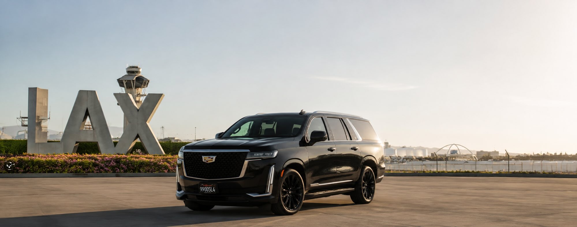 Black Cadillac Escalade ESV staged for a private pickup at Los Angeles International Airport