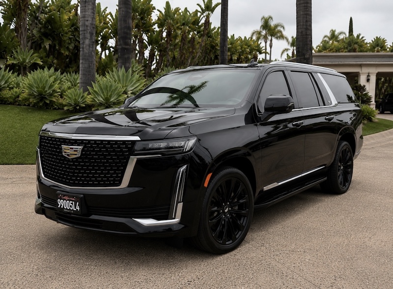Black chauffeured SUV waiting on a private driveway